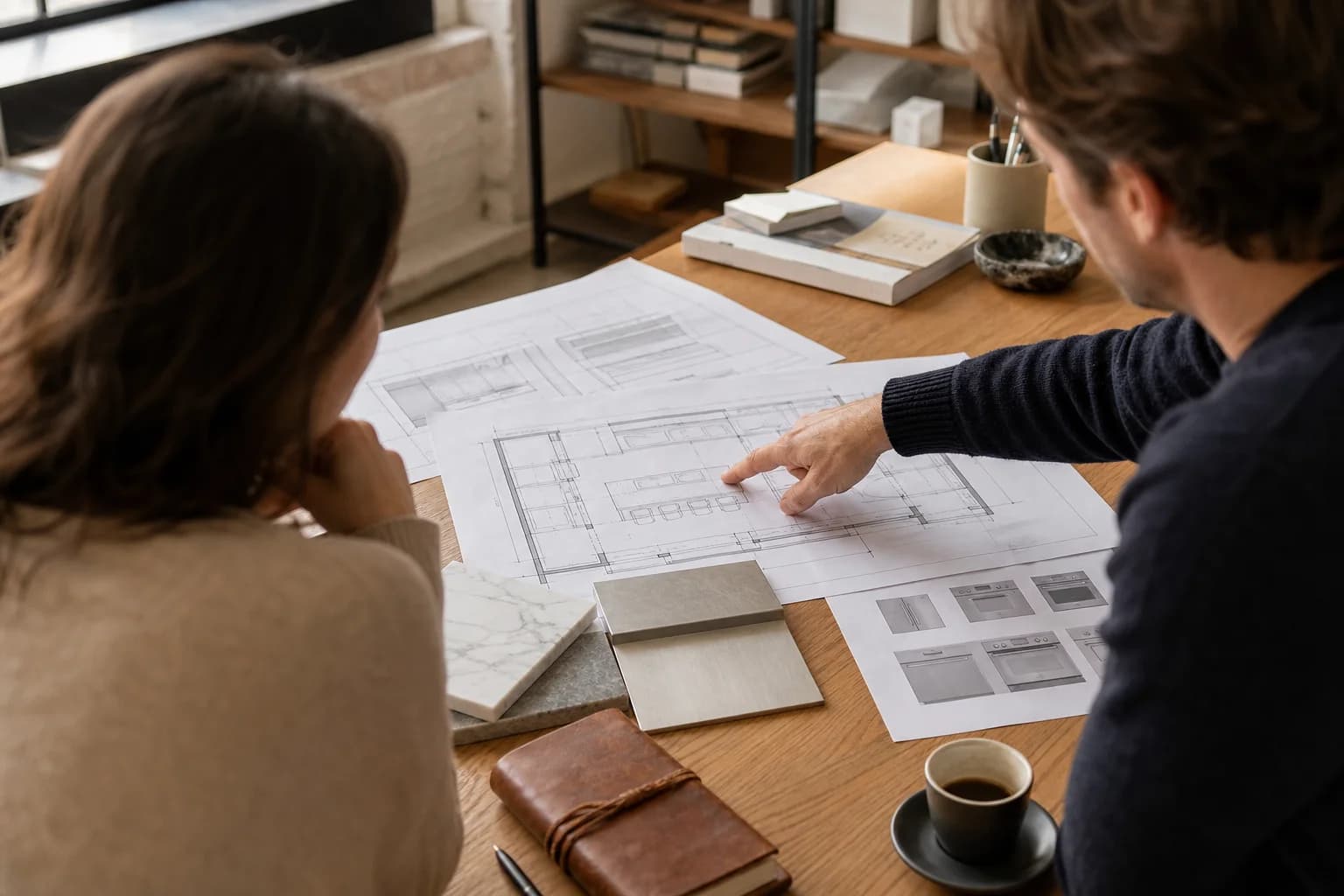 Specialists reviewing kitchen plans and appliance specifications